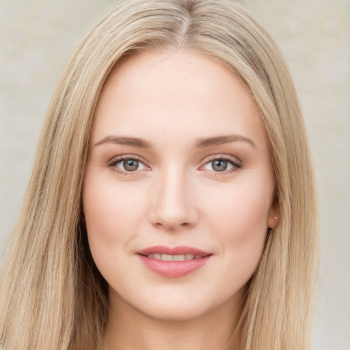 Joyful white young-adult female with long  brown hair and green eyes