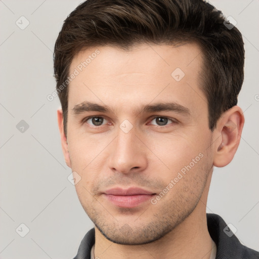 Joyful white young-adult male with short  brown hair and brown eyes