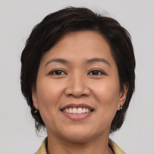 Joyful white adult female with medium  brown hair and brown eyes