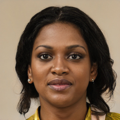 Joyful black young-adult female with medium  black hair and brown eyes