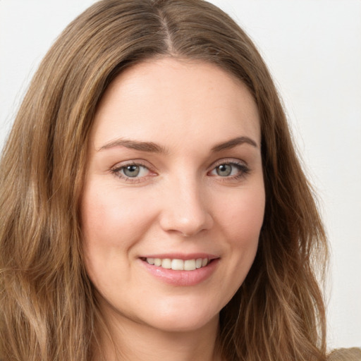 Joyful white young-adult female with long  brown hair and green eyes