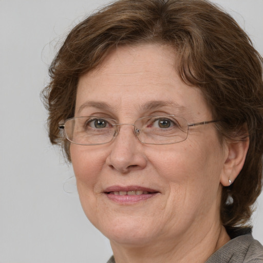 Joyful white middle-aged female with medium  brown hair and blue eyes