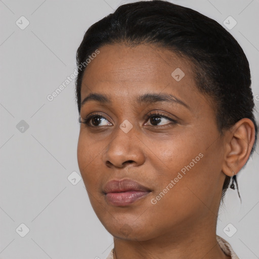 Joyful black young-adult female with short  black hair and brown eyes