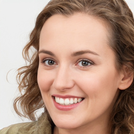 Joyful white young-adult female with long  brown hair and green eyes