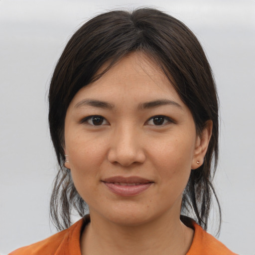 Joyful asian young-adult female with medium  brown hair and brown eyes