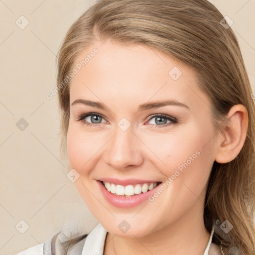 Joyful white young-adult female with medium  brown hair and blue eyes