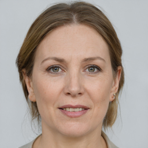 Joyful white adult female with medium  brown hair and grey eyes