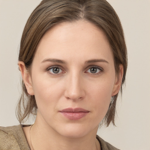 Joyful white young-adult female with medium  brown hair and grey eyes