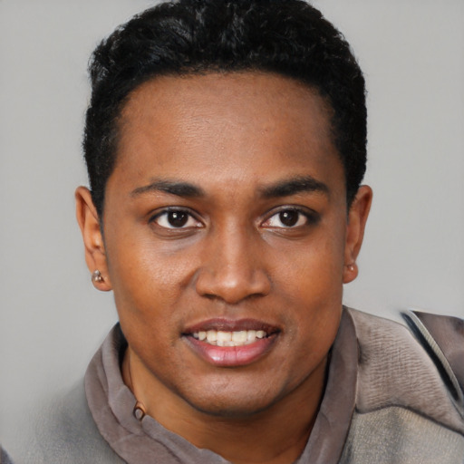 Joyful black young-adult male with short  black hair and brown eyes