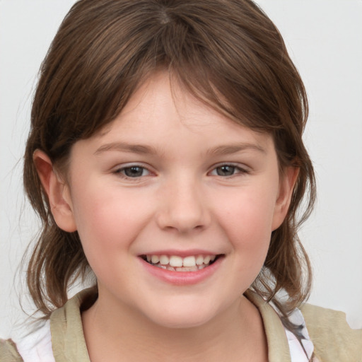 Joyful white child female with medium  brown hair and grey eyes