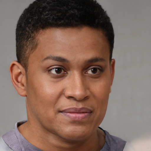 Joyful black young-adult male with short  brown hair and brown eyes