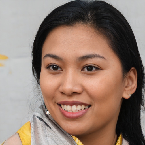 Joyful asian young-adult female with medium  brown hair and brown eyes