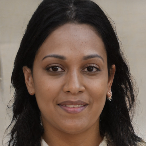 Joyful white young-adult female with long  brown hair and brown eyes