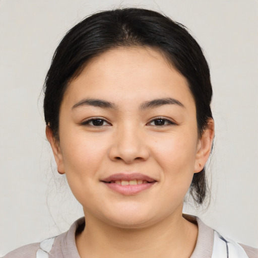 Joyful latino young-adult female with medium  black hair and brown eyes