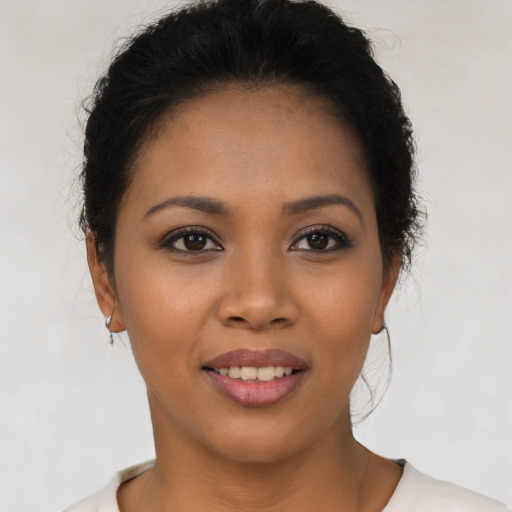 Joyful latino young-adult female with short  brown hair and brown eyes