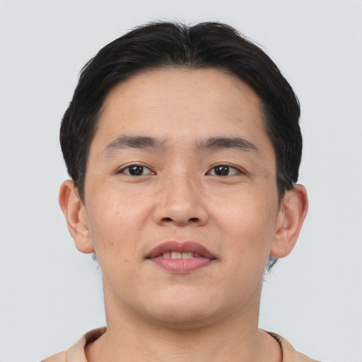 Joyful asian young-adult male with short  brown hair and brown eyes