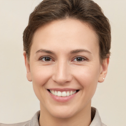 Joyful white young-adult female with short  brown hair and brown eyes