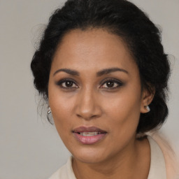 Joyful black adult female with medium  brown hair and brown eyes