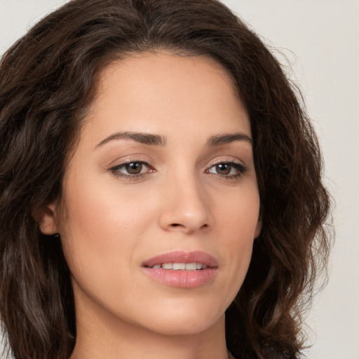 Joyful white young-adult female with long  brown hair and brown eyes