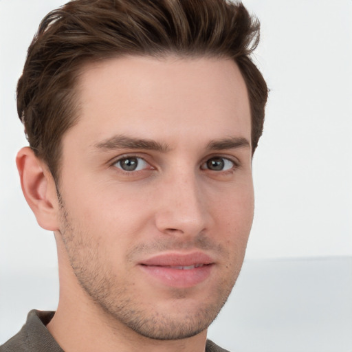 Joyful white young-adult male with short  brown hair and grey eyes