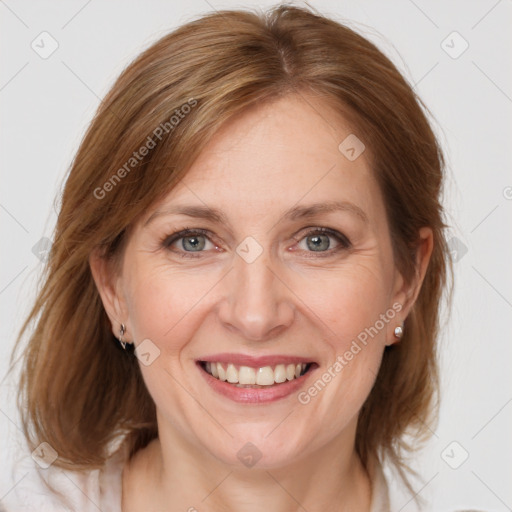 Joyful white adult female with medium  brown hair and grey eyes