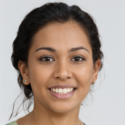 Joyful latino young-adult female with medium  brown hair and brown eyes