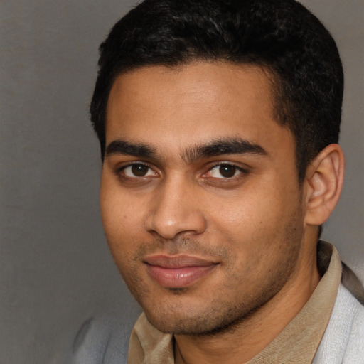 Joyful latino young-adult male with short  brown hair and brown eyes