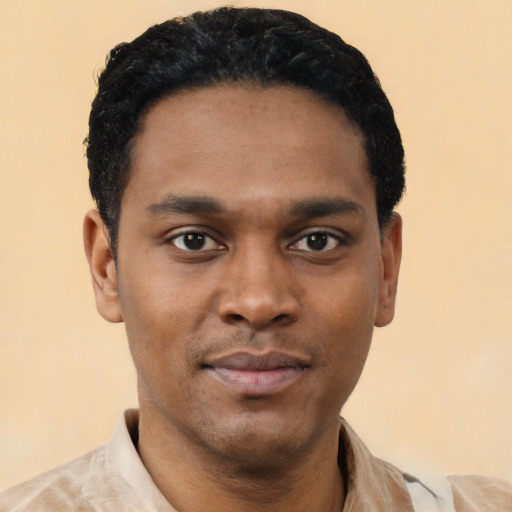 Joyful black young-adult male with short  black hair and brown eyes