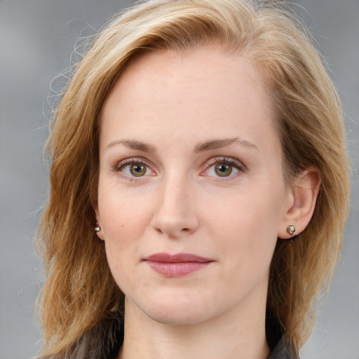 Joyful white young-adult female with medium  brown hair and blue eyes