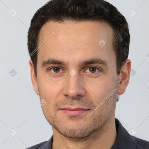 Joyful white adult male with short  brown hair and brown eyes