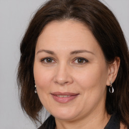 Joyful white adult female with medium  brown hair and brown eyes