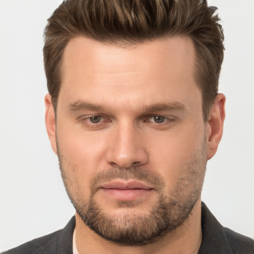 Joyful white young-adult male with short  brown hair and brown eyes