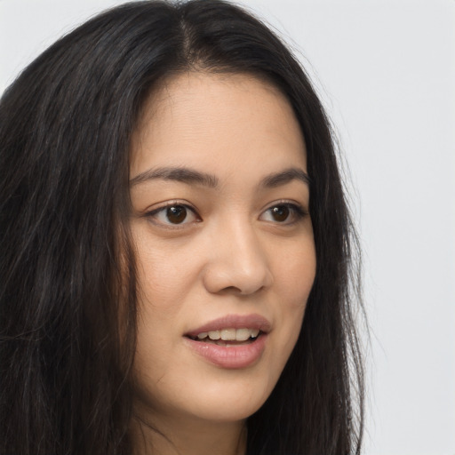 Joyful asian young-adult female with long  brown hair and brown eyes