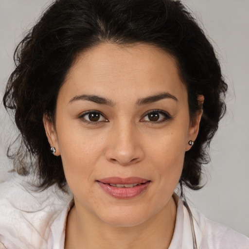 Joyful latino young-adult female with medium  brown hair and brown eyes