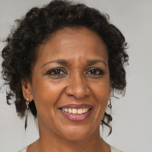 Joyful black adult female with medium  brown hair and brown eyes
