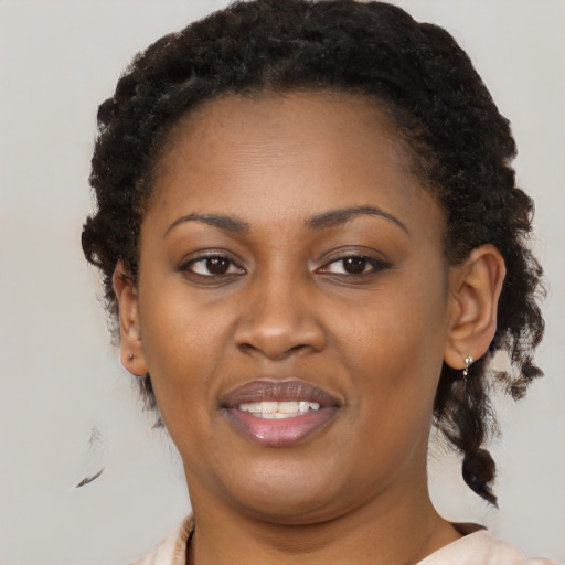 Joyful black young-adult female with medium  brown hair and brown eyes