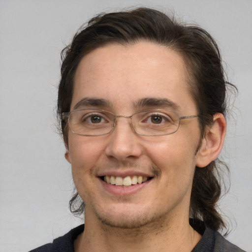 Joyful white adult male with medium  brown hair and brown eyes