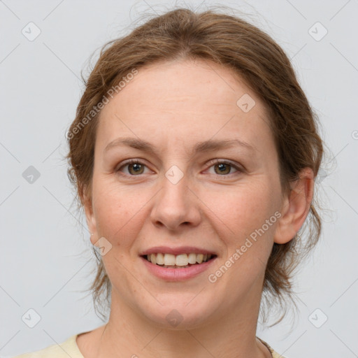 Joyful white adult female with medium  brown hair and green eyes