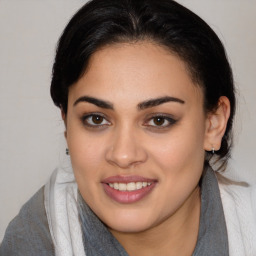 Joyful latino young-adult female with medium  brown hair and brown eyes