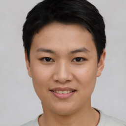 Joyful asian young-adult female with short  black hair and brown eyes