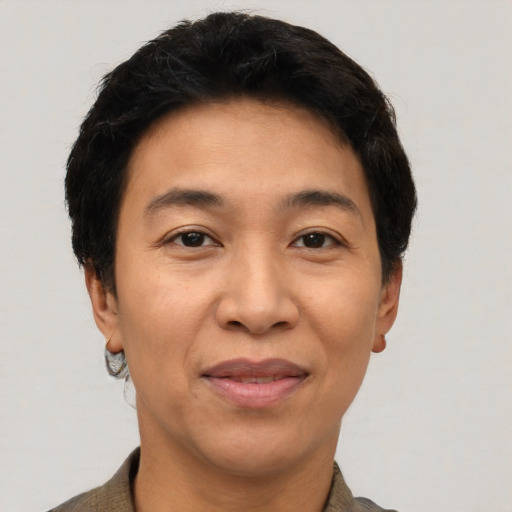 Joyful asian adult female with short  black hair and brown eyes