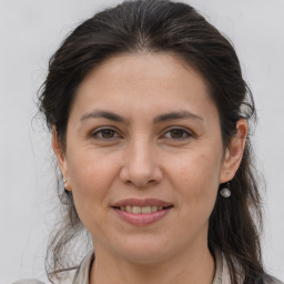 Joyful white adult female with medium  brown hair and brown eyes