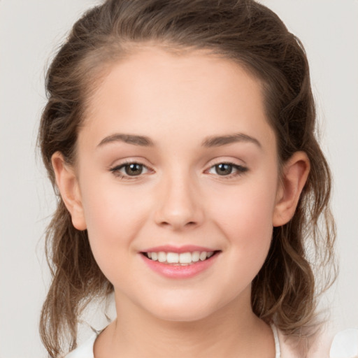 Joyful white child female with medium  brown hair and grey eyes