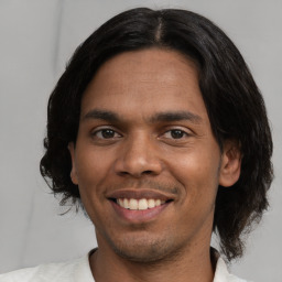 Joyful white young-adult male with short  black hair and brown eyes