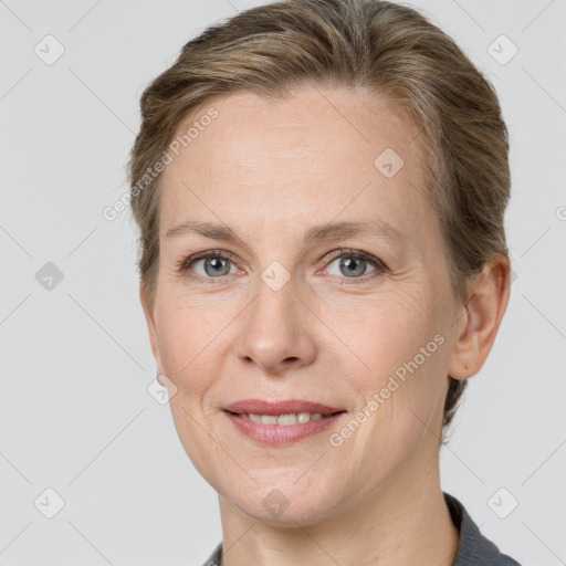 Joyful white adult female with short  brown hair and grey eyes