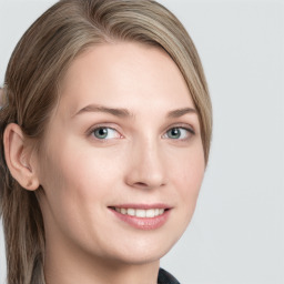 Joyful white young-adult female with long  brown hair and blue eyes