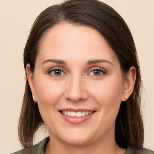 Joyful white young-adult female with long  brown hair and brown eyes