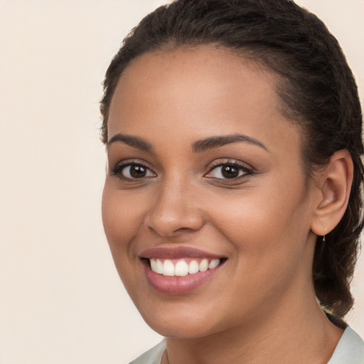 Joyful white young-adult female with long  brown hair and brown eyes