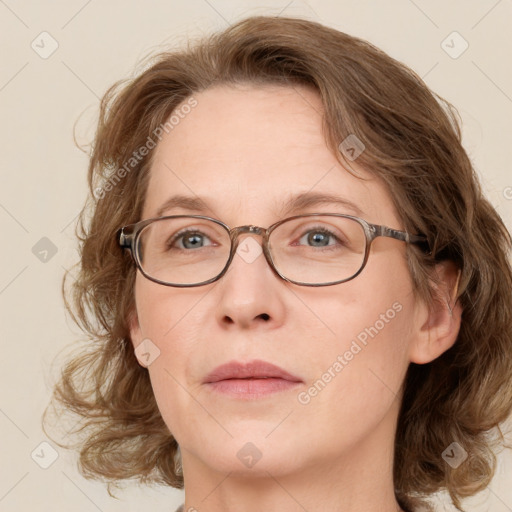 Joyful white adult female with medium  brown hair and green eyes