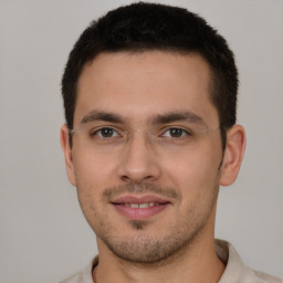 Joyful white young-adult male with short  brown hair and brown eyes